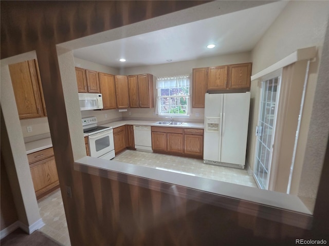 8911 Tappy Toorie Pl, Highlands Ranch, CO 80129 - kitchen with white appliances, light countertops, brown cabinetry, and recessed lighting