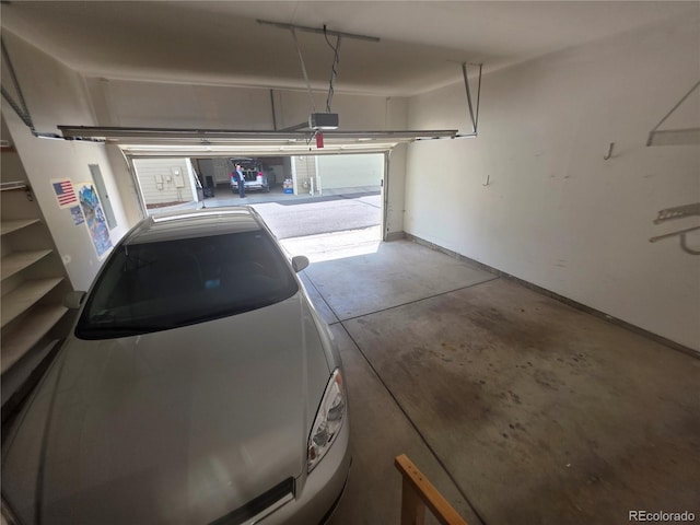 8911 Tappy Toorie Pl, Highlands Ranch, CO 80129 - garage featuring a garage door opener and baseboards