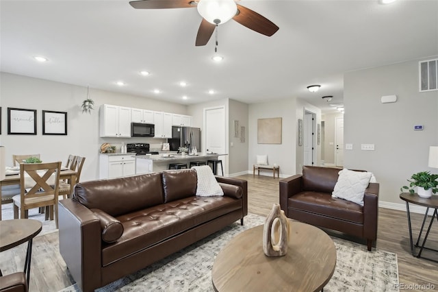 2328 Saddle Back Ct, Fort Lupton, CO 80621 - living area featuring light wood-type flooring, baseboards, ceiling fan, and recessed lighting
