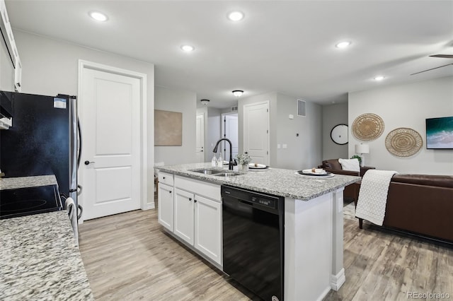 2328 Saddle Back Ct, Fort Lupton, CO 80621 - kitchen featuring dishwasher, a sink, white cabinetry, light wood-style floors, and recessed lighting