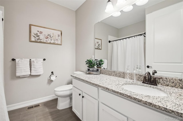 2328 Saddle Back Ct, Fort Lupton, CO 80621 - bathroom with baseboards, vanity, toilet, wood finished floors, and a shower with curtain