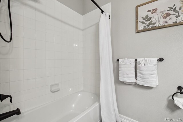 2328 Saddle Back Ct, Fort Lupton, CO 80621 - bathroom with shower / bathtub combination with curtain and baseboards