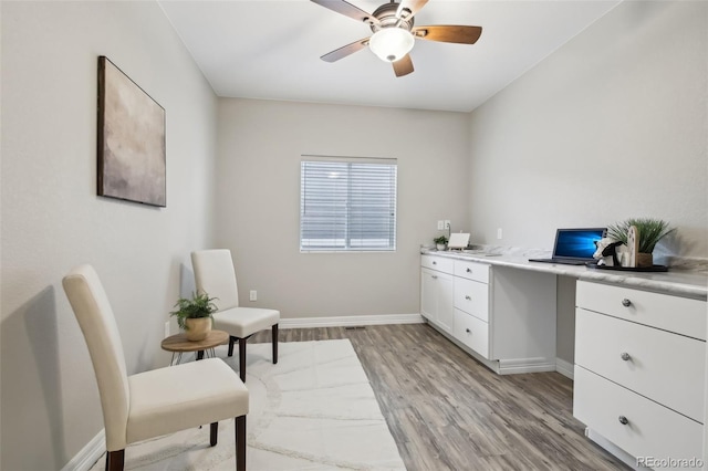2328 Saddle Back Ct, Fort Lupton, CO 80621 - home office featuring a ceiling fan, light wood-style flooring, baseboards, and built in study area