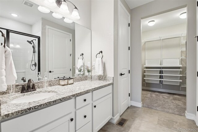 2328 Saddle Back Ct, Fort Lupton, CO 80621 - full bathroom featuring vanity, baseboards, a stall shower, and tile patterned floors
