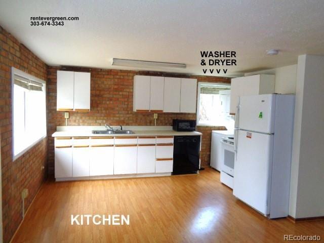 28127 Knowles Rd Unit A, B, & C, Evergreen, CO 80439 - kitchen featuring black appliances, white cabinets, light wood finished floors, light countertops, and brick wall