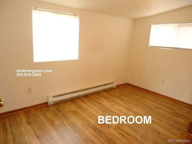 28127 Knowles Rd Unit A, B, & C, Evergreen, CO 80439 - empty room featuring baseboard heating and wood finished floors