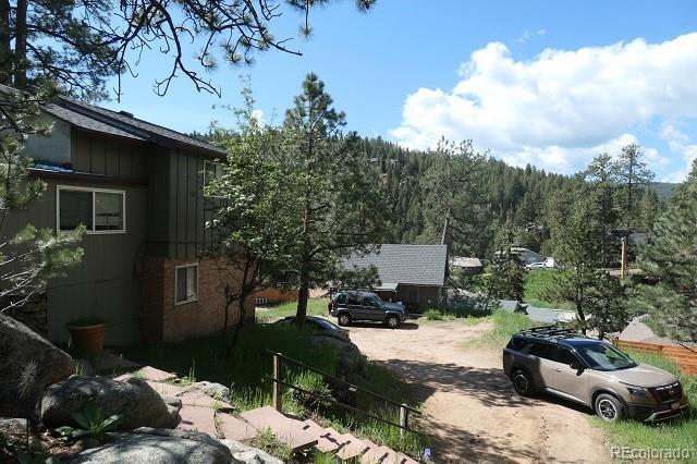 28127 Knowles Rd Unit A, B, & C, Evergreen, CO 80439 - view of dirt / gravel road with a wooded view