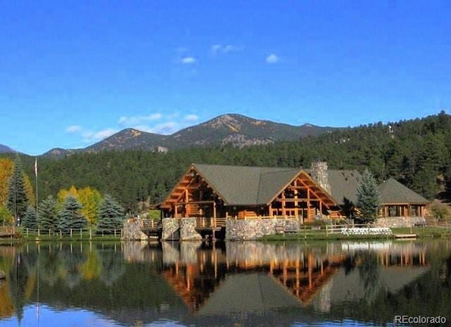 28127 Knowles Rd Unit A, B, & C, Evergreen, CO 80439 - water view featuring a mountainous background and a heavily wooded area