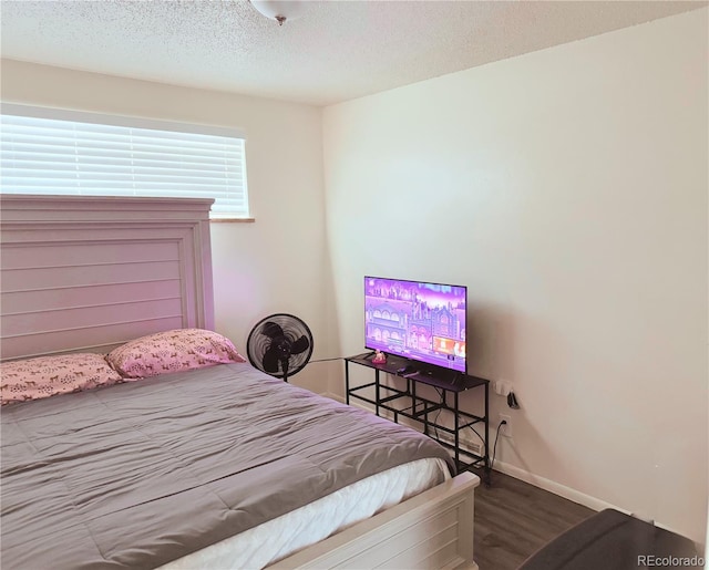 bedroom featuring hardwood / wood-style floors and a textured ceiling