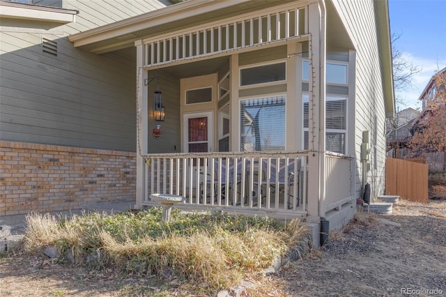 view of exterior entry with a porch