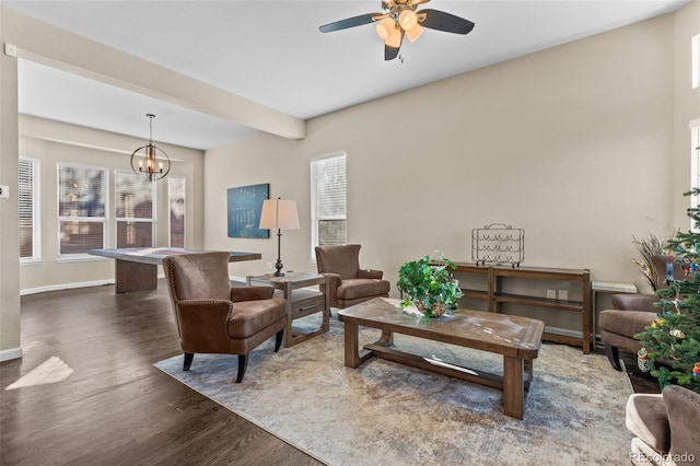 living room with ceiling fan with notable chandelier, dark hardwood / wood-style floors, and plenty of natural light