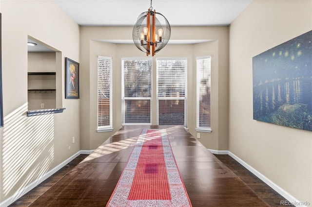 interior space featuring a chandelier and dark hardwood / wood-style floors