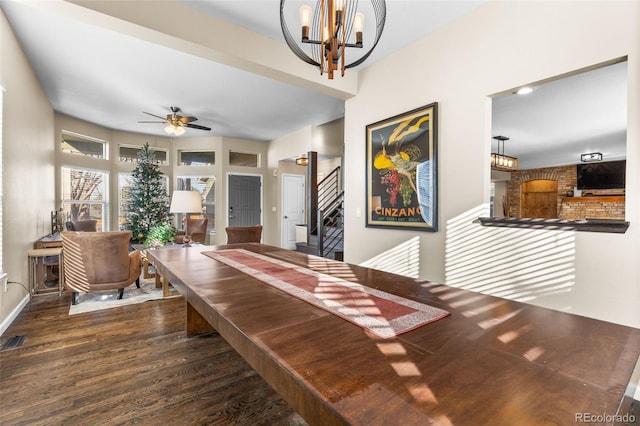 dining area featuring dark hardwood / wood-style floors and ceiling fan with notable chandelier