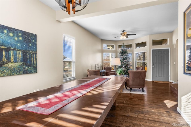 living room featuring ceiling fan with notable chandelier and dark hardwood / wood-style floors