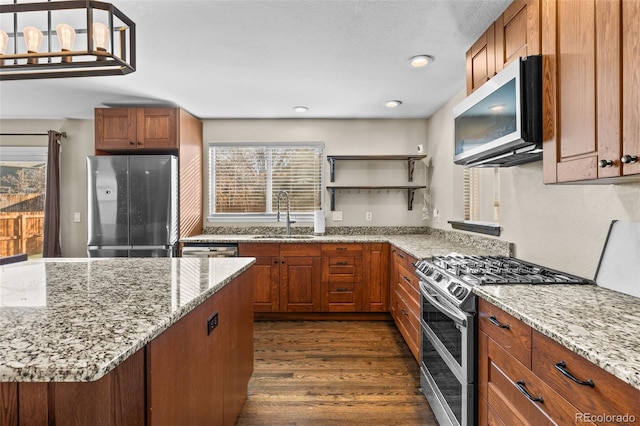 kitchen featuring sink, light stone countertops, stainless steel appliances, and dark wood-type flooring