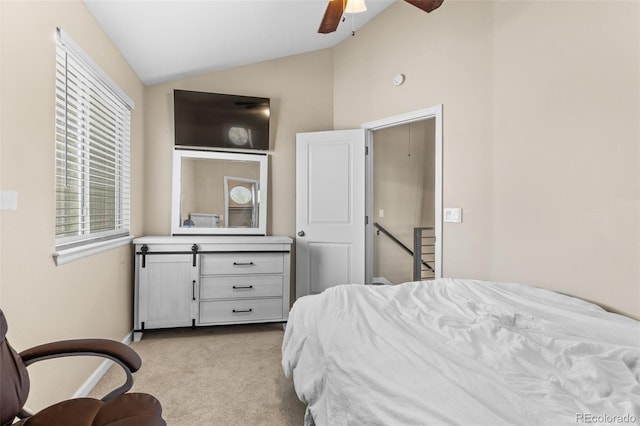 bedroom featuring ceiling fan, light colored carpet, and vaulted ceiling