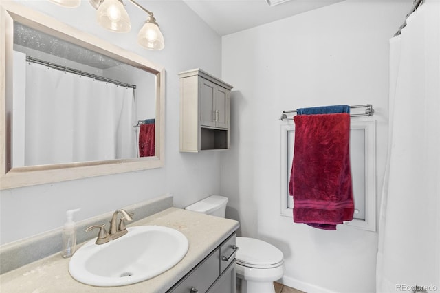 bathroom featuring vanity and toilet