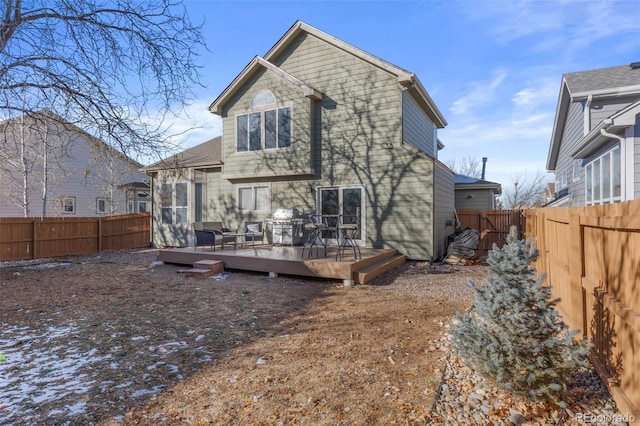 back of property with a wooden deck