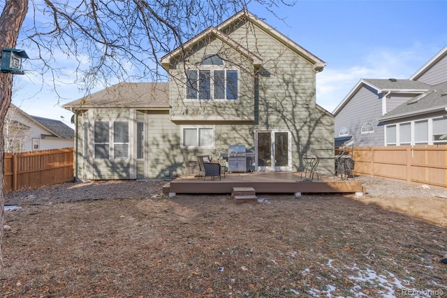 rear view of property with a wooden deck