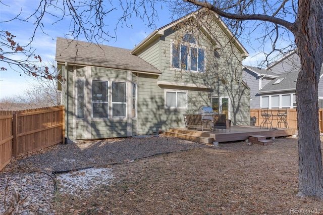 rear view of house featuring a deck