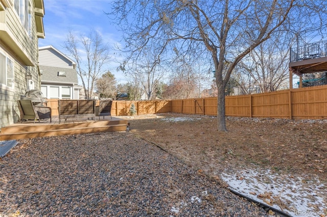 yard layered in snow with a deck