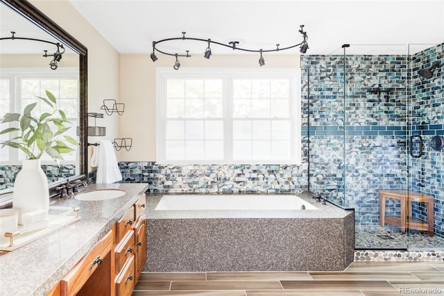 9867 W Berry Dr, Littleton, CO 80123 - bathroom featuring a stall shower, vanity, a garden tub, and wood tiled floors
