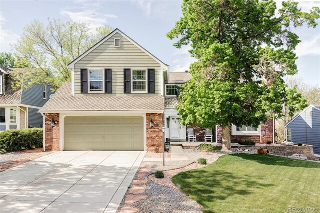 9867 W Berry Dr, Littleton, CO 80123 - view of front of property with concrete driveway, brick siding, an attached garage, a shingled roof, and a front yard