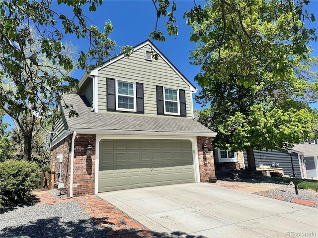 9867 W Berry Dr, Littleton, CO 80123 - view of front of property with brick siding, an attached garage, driveway, and roof with shingles