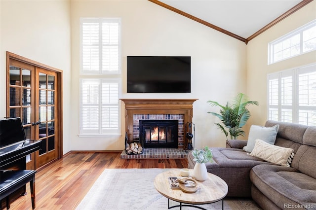 9867 W Berry Dr, Littleton, CO 80123 - living area with high vaulted ceiling, wood finished floors, crown molding, french doors, and a fireplace