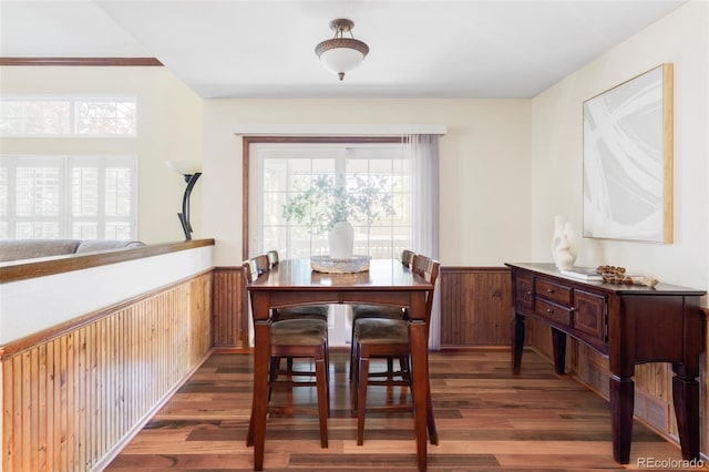 9867 W Berry Dr, Littleton, CO 80123 - dining space featuring wainscoting, wood finished floors, and wooden walls