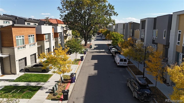 view of road featuring sidewalks, a residential view, and curbs