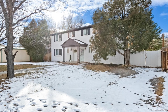 view of front of house featuring a garage and fence