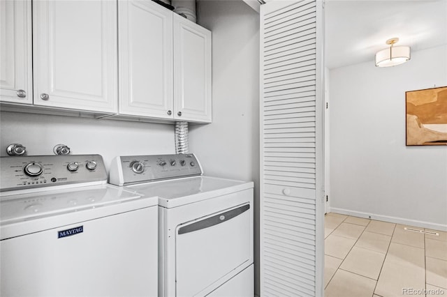 washroom featuring cabinet space, light tile patterned flooring, baseboards, and independent washer and dryer