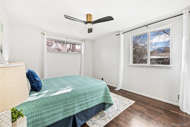 bedroom featuring visible vents, wood finished floors, a ceiling fan, and baseboards