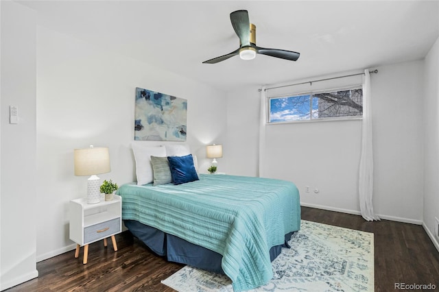 bedroom featuring ceiling fan, baseboards, and wood finished floors