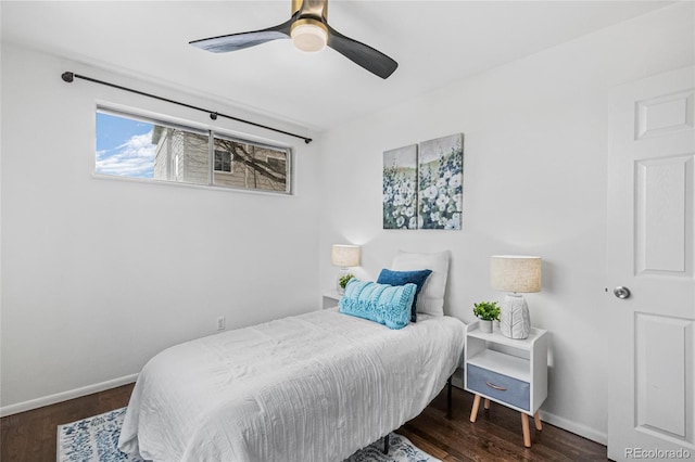 bedroom with a ceiling fan, baseboards, and wood finished floors