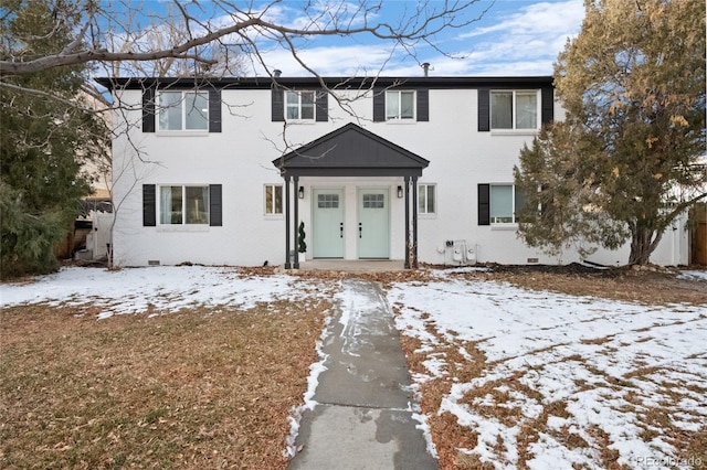 view of front of house featuring crawl space and brick siding