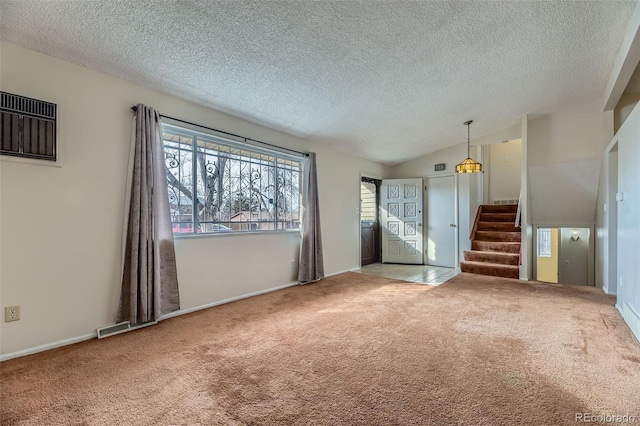 unfurnished living room featuring stairs, vaulted ceiling, carpet, and a textured ceiling