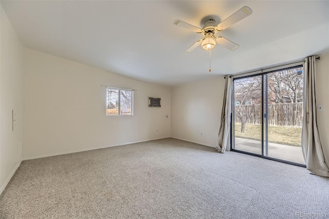 carpeted spare room featuring ceiling fan and vaulted ceiling