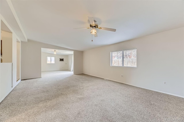 empty room featuring carpet, ceiling fan, and baseboards