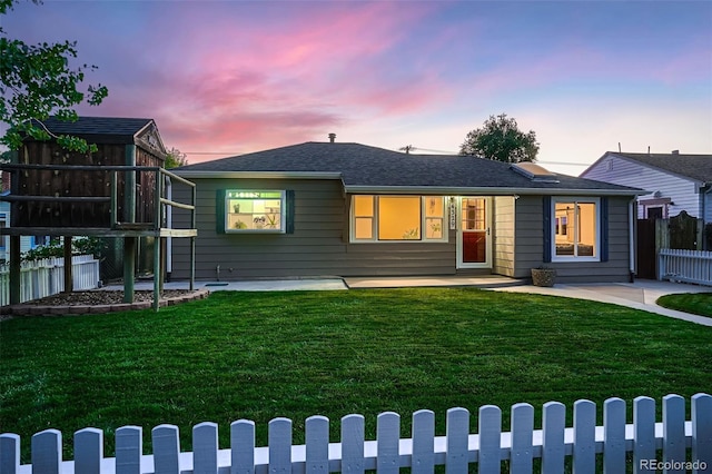 view of front of home with a patio area and a lawn