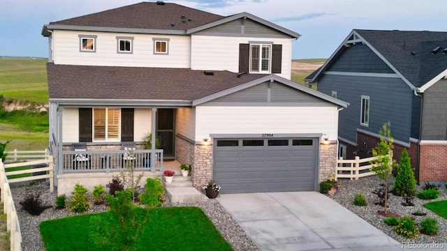 27994 E Indore Dr, Aurora, CO 80016 - view of front facade with covered porch, driveway, brick siding, and roof with shingles