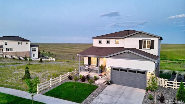 27994 E Indore Dr, Aurora, CO 80016 - view of front of property with a porch, driveway, stone siding, and a view of rural / pastoral area