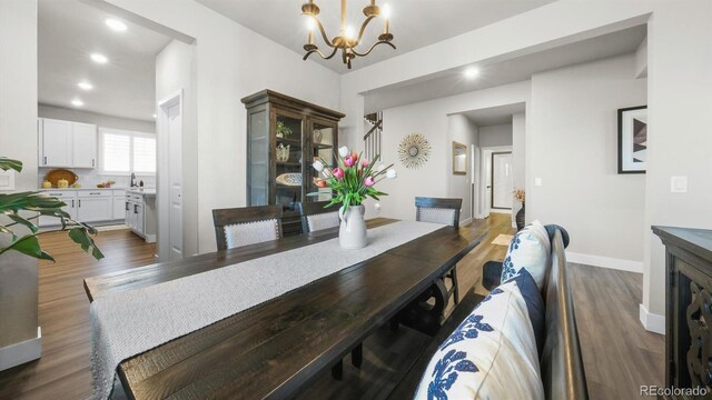 27994 E Indore Dr, Aurora, CO 80016 - dining area with dark wood-type flooring, a chandelier, and recessed lighting