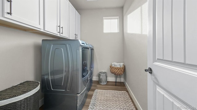 27994 E Indore Dr, Aurora, CO 80016 - washroom with washer and dryer, cabinet space, and wood finished floors