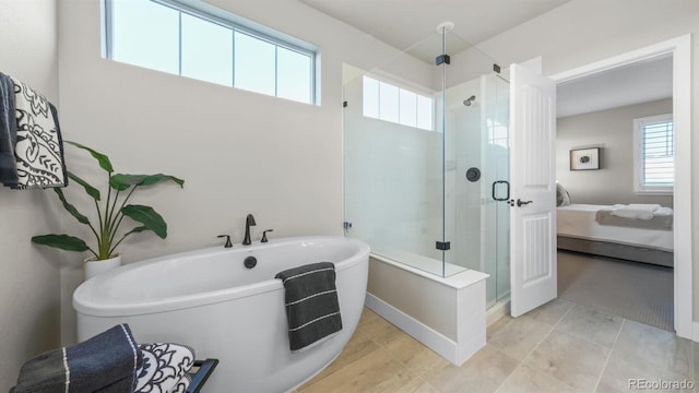 27994 E Indore Dr, Aurora, CO 80016 - ensuite bathroom featuring a soaking tub, a stall shower, and tile patterned flooring