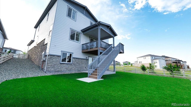 27994 E Indore Dr, Aurora, CO 80016 - back of house with stone siding, a fenced backyard, and stairway