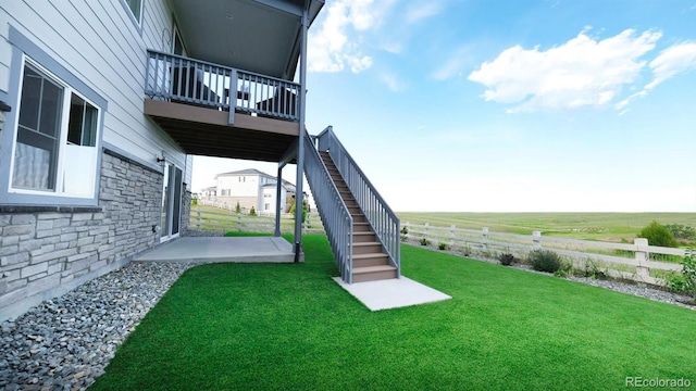 27994 E Indore Dr, Aurora, CO 80016 - view of yard featuring a balcony, stairs, a patio, and a rural view