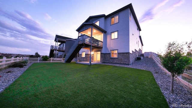 27994 E Indore Dr, Aurora, CO 80016 - back of house with stone siding, stairs, a fenced backyard, a deck, and a patio area