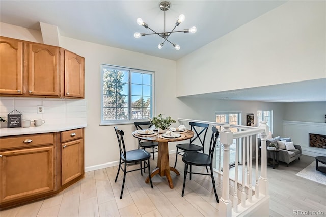 dining room with light hardwood / wood-style flooring and a chandelier